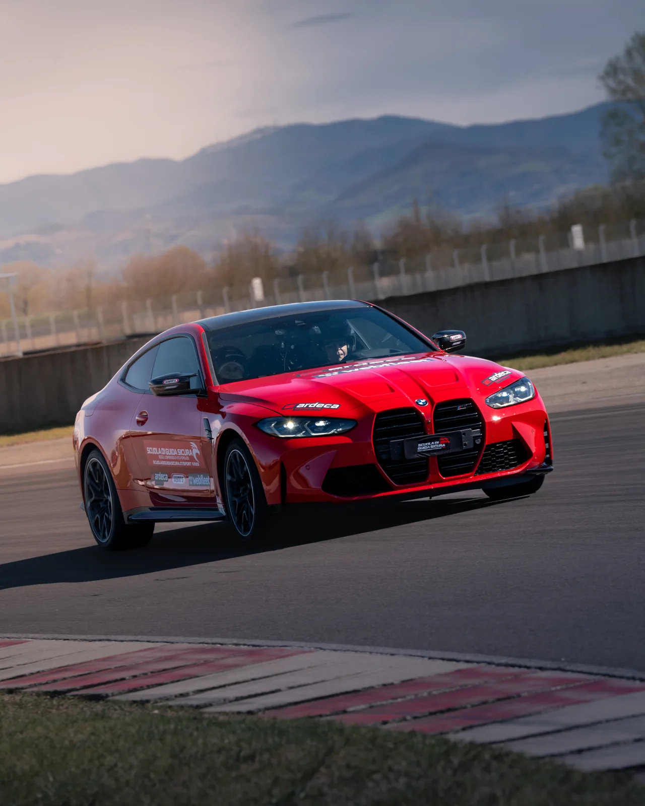 BMW rossa ripresa vicino al cordolo del circuito Tazio Nuvolari