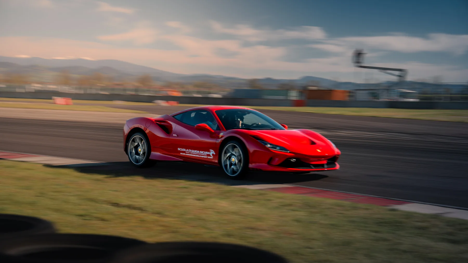 Ferrari rossa in movimento sul circuito Tazio Nuvolari